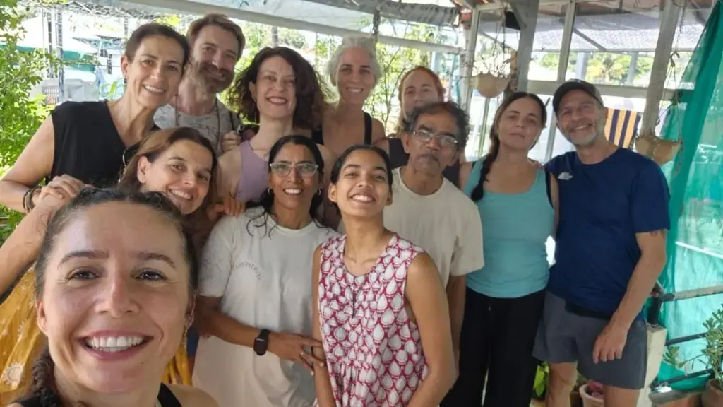 Guests and teachers crowded together in a smiling group selfie