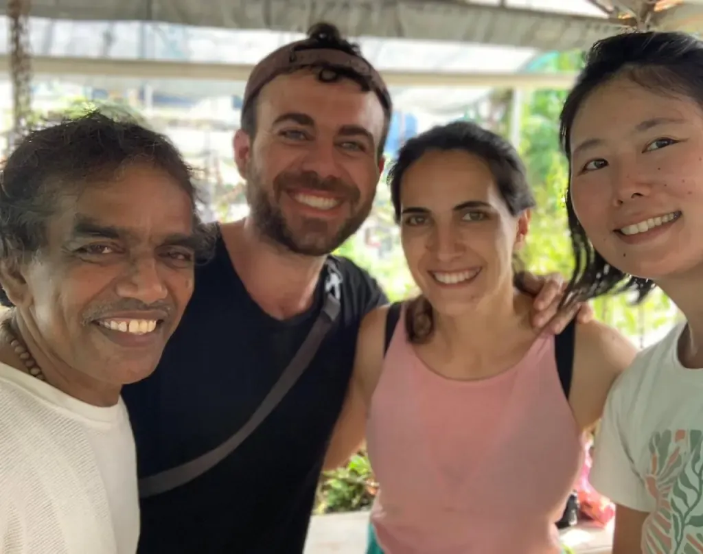 Three guests sharing a smiling selfie with their Ayurtheeram teacher
