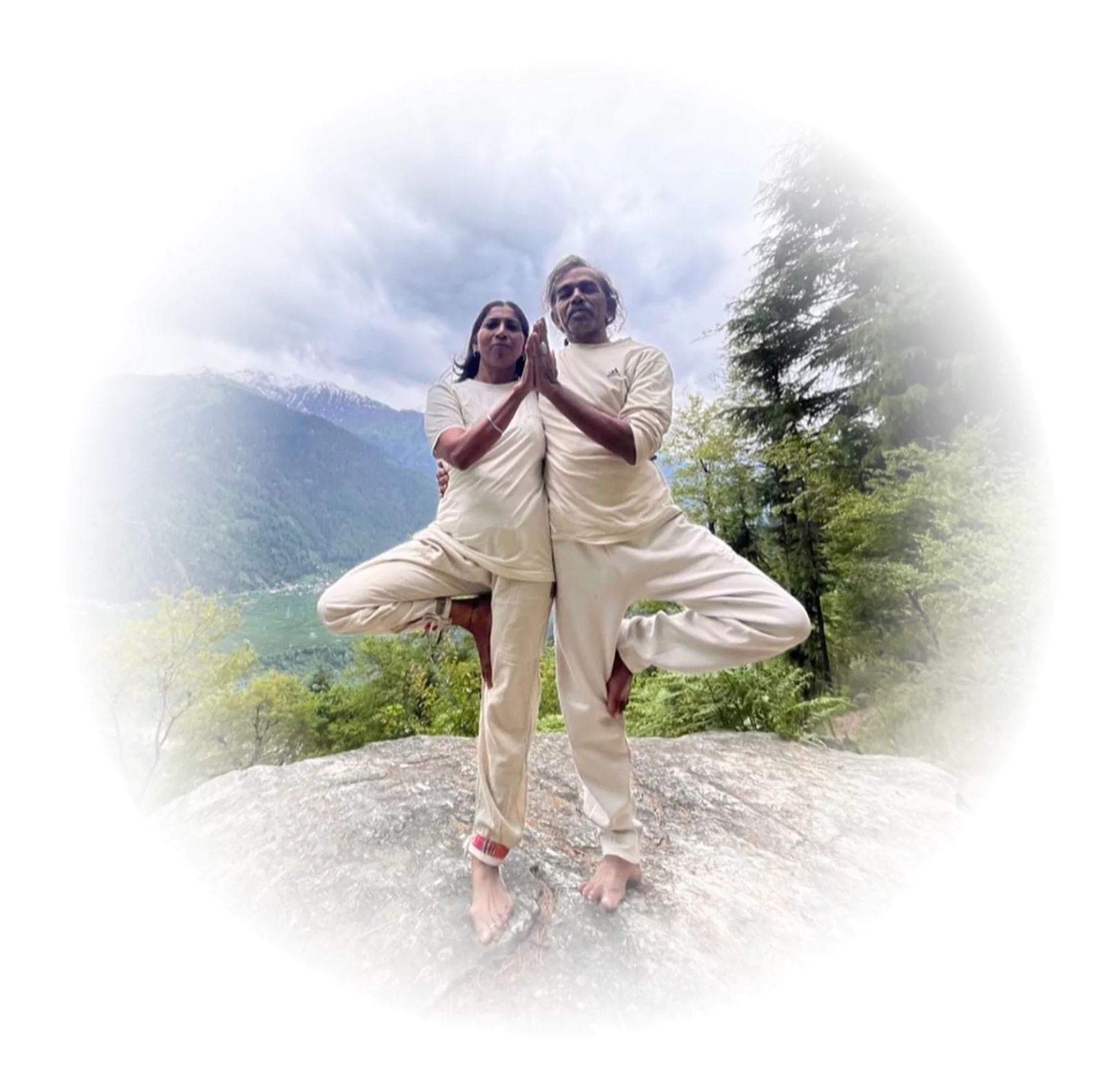 Yoga practitioners in tree pose with a mountain backdrop